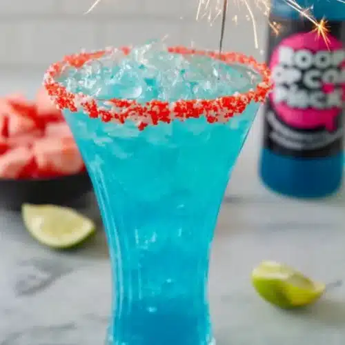 Firecracker Margarita 4 Firecracker Margarita with blue cocktail, red candy rim, and sparkler